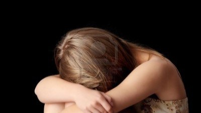 5361641-young-woman-depression-isolated-on-black-background